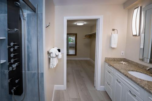 a bathroom with a shower and a sink at Cedar Cove Resort & Cottages in Holmes Beach