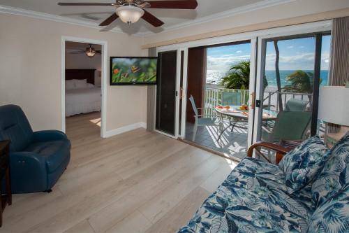 a living room with a couch and a view of the ocean at Cedar Cove Resort & Cottages in Holmes Beach