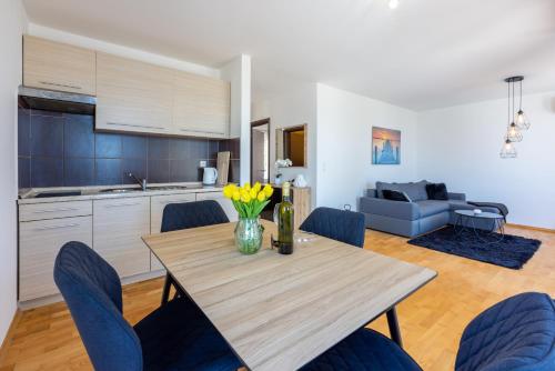 a kitchen and dining room with a table and chairs at Marie in Crikvenica