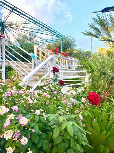 a bunch of flowers in front of a white staircase at Villa Elisa in Minturno