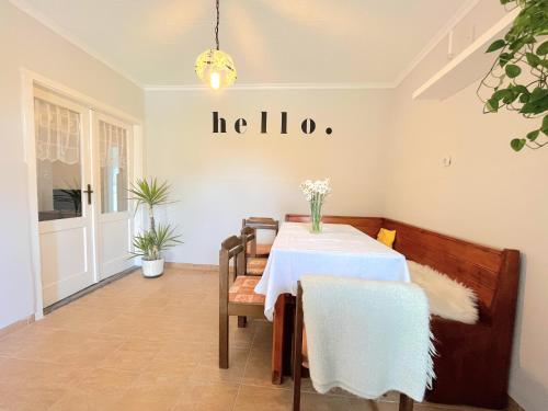 a dining room with a table and a sign that reads halo at Holiday Home Szulok in Szulok