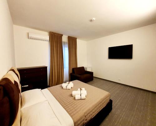 a hotel room with a bed and a chair at Camere Fiera Verona - CasaNostra in Verona