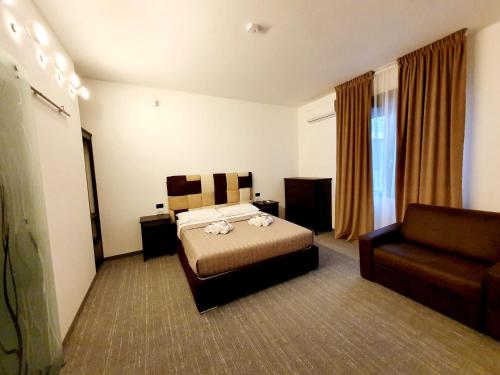 a hotel room with a bed and a couch at Camere Fiera Verona - CasaNostra in Verona