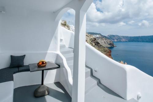 a view of the ocean from the balcony of a house at Virginia's Cave Villas in Oia
