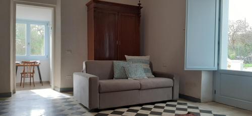a living room with a couch and a table at Lispusada Agriturismo Adults Only in Biancareddu