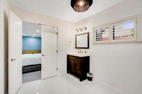 a white bathroom with a sink and a mirror at Style & Shade in Horseshoe Bay