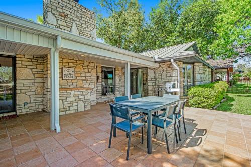 a stone house with a table and chairs on a patio at Style & Shade in Horseshoe Bay