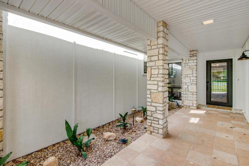 an empty house with a wall with a stone pillar at Style & Shade in Horseshoe Bay
