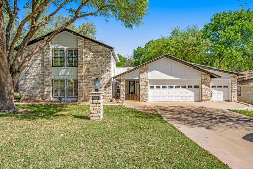 a brick house with a garage at Style & Shade in Horseshoe Bay