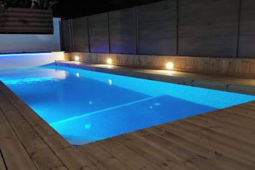 a swimming pool with blue water and lights at SunnyVillas: 4BR Villa☆Private Pool + Jacuzzi - Villa Amelie in Protaras