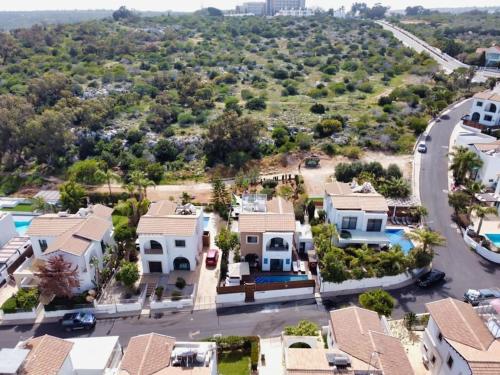 an aerial view of a subdivision of houses at SunnyVillas: 4BR Villa☆Private Pool + Jacuzzi - Villa Amelie in Protaras