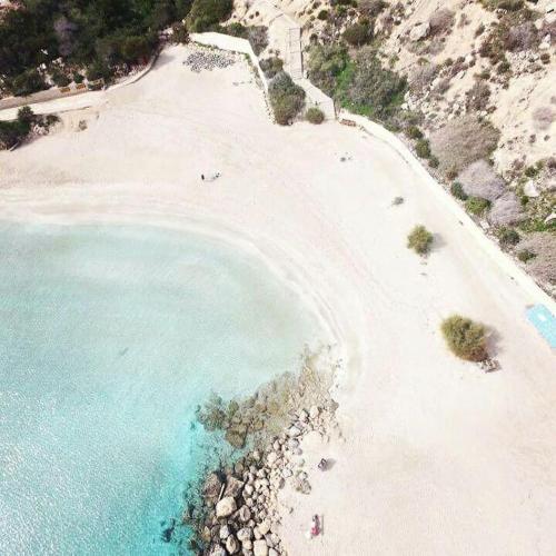 an aerial view of a beach with people in the water at SunnyVillas: 4BR Villa☆Private Pool + Jacuzzi - Villa Amelie in Protaras