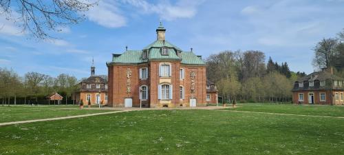 a large brick building with a green roof at Ferienwohnung Prinz in Lathen