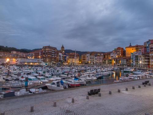 a group of boats docked in a marina at night at Hotel Branka in Mundaka