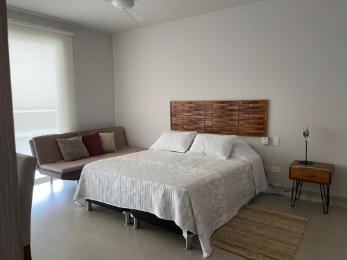 Ένα ή περισσότερα κρεβάτια σε δωμάτιο στο Cartagena, gran experiencia frente al mar a 20 minutos del centro histórico y 13 minutos del aeropuerto