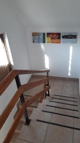 a table and a bench sitting next to a wall at Apartment Mila in Plitvička Jezera