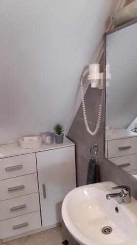 a bathroom with a sink and a mirror at Apartment Mila in Plitvička Jezera