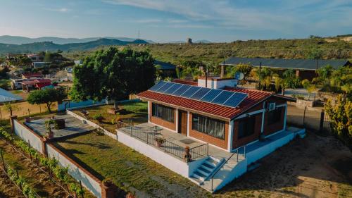 a house with solar panels on top of it at Quinta Sofia Valle de Guadalupe in Valle de Guadalupe