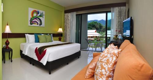 a bedroom with a bed and a couch at Poonyamantra Resort in Ban Rai