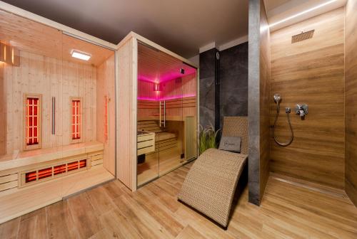 a bathroom with a shower and a bench in a room at Villa Natura Rewa in Rewa