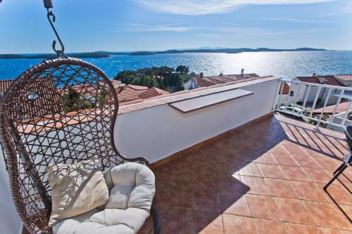 a swing on a balcony with a view of the water at Apartmani Marinka Viskovic in Hvar