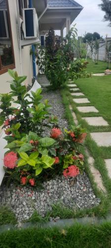 a garden with flowers on the side of a house at Joleen Safari Park in Dar es Salaam