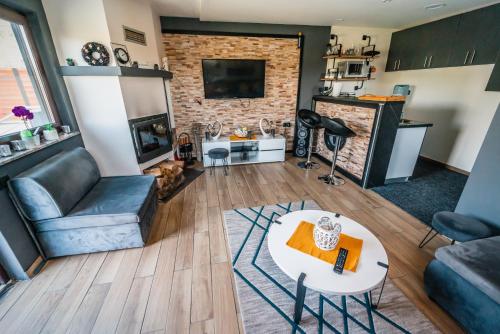 a living room with a couch and a table at Kuća za odmor Mladen i Martina in Slavonski Brod