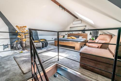 a room with a balcony with a bed and a couch at Kuća za odmor Mladen i Martina in Slavonski Brod