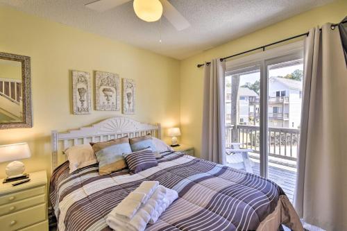 a bedroom with a bed and a sliding glass door at Home with Deck in Corolla Light Walk to Beach! in Corolla