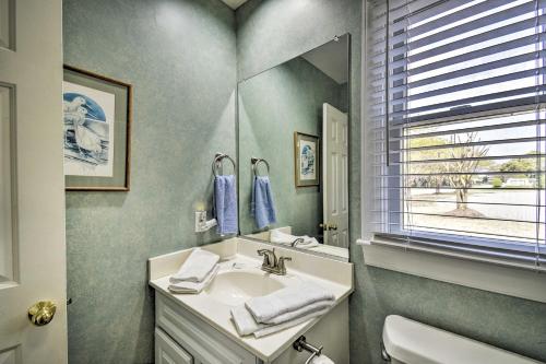 a bathroom with a sink and a mirror at Home with Deck in Corolla Light Walk to Beach! in Corolla