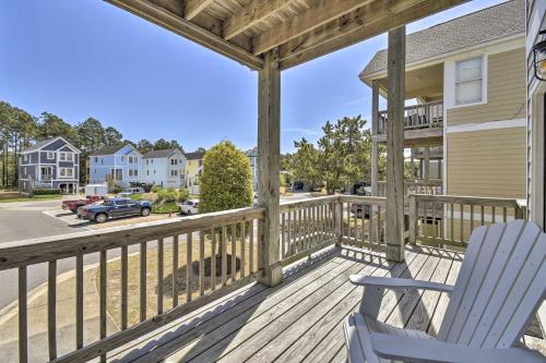 a rocking chair on a deck with a view of a street at Home with Deck in Corolla Light Walk to Beach! in Corolla