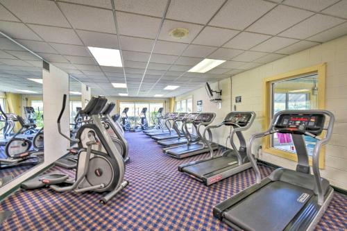a gym with rows of treadmills and elliptical machines at Home with Deck in Corolla Light Walk to Beach! in Corolla