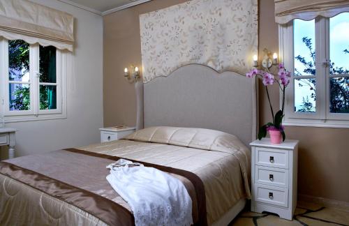 
a bedroom with a bed and a dresser at Dafnoudi Hotel Apartments in Fiskardo
