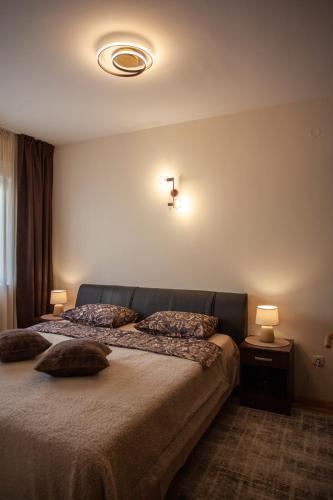 a bedroom with a bed with two pillows on it at Villa Nova in Đenovići