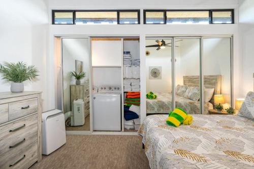 a bedroom with a bed and a sliding glass door at Modern-Rustic Beach Renovation Direct Oceanfront Penthouse in Kahana