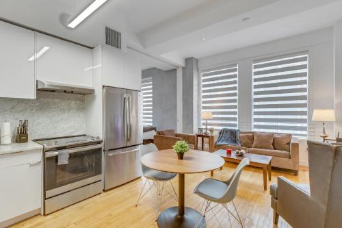 a kitchen and living room with a table and chairs at One Lux Stay HWH Downtown Los Angeles in Los Angeles