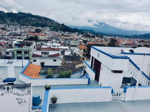 a view of a city from the roof of a building at Hostal Chasqui in Otavalo