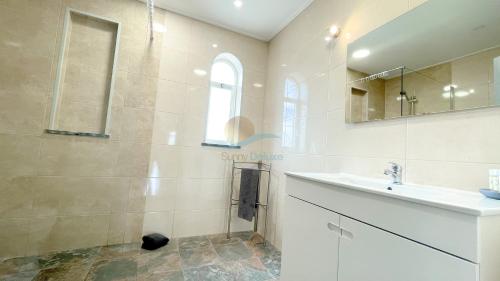 a bathroom with a sink and a mirror at Vila Ricardo by Sunny Deluxe in Albufeira