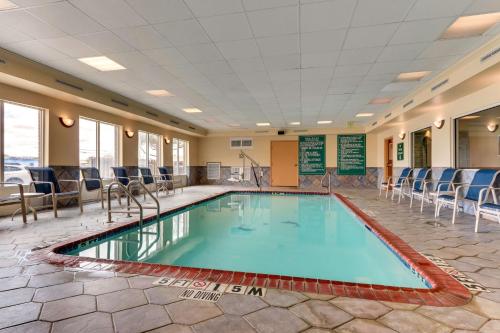 a pool in the middle of a room with chairs at Best Western Plus Woodway Waco South Inn & Suites in Waco