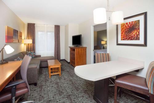 a living room of a hotel room with a couch and a table at Sonesta ES Suites Atlanta Perimeter Center in Atlanta