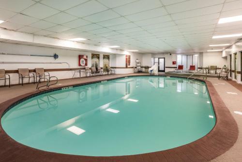 a large swimming pool with blue water in a hotel room at SureStay Hotel by Best Western SeaTac Airport North in SeaTac