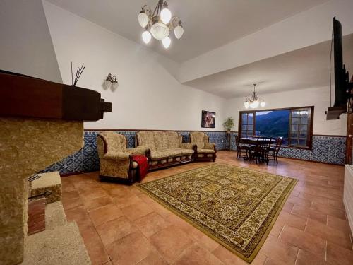a living room with a couch and a piano at Villa Bouro - Breathtaking scenery near Gerês in Terras de Bouro