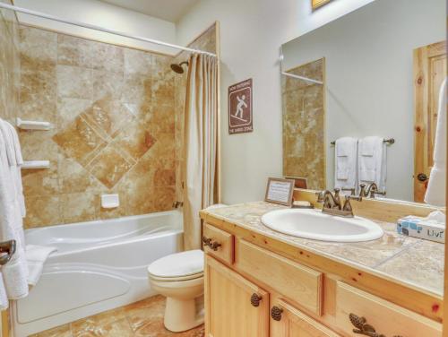 a bathroom with a sink and a tub and a toilet at Barlow Trail Lodge - Meredith Lodging in Rhododendron