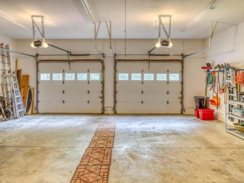 an empty garage with two garage doors and windows at Barlow Trail Lodge - Meredith Lodging in Rhododendron