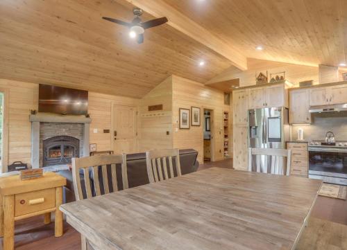 a kitchen with a large wooden table in a cabin at River View Cabin - Meredith Lodging in Welches