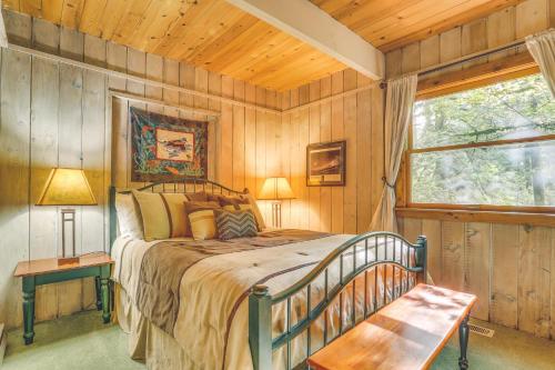 a bedroom with a bed in a room with wooden walls at River Dance Retreat - Meredith Lodging in Welches