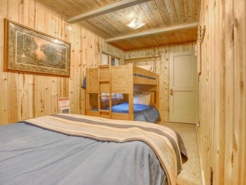 a bedroom with a bunk bed in a log cabin at Storybrooks Cabin - Meredith Lodging in Rhododendron
