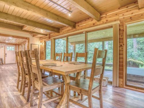 a dining room with a wooden table and chairs at Ripplewood - Meredith Lodging in Welches