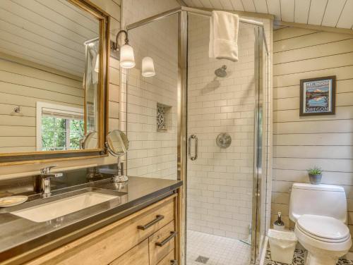 a bathroom with a toilet and a sink and a shower at Thistle Dew - Meredith Lodging in Welches