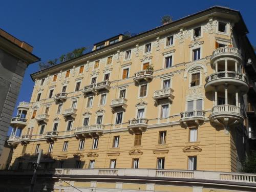 um edifício amarelo com varandas ao lado em Palazzo Gropallo Rooms em Génova